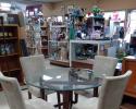 This glass table with grey suede, high back chairs would make a great addition to any dinning room! 